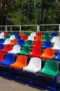 Colorful empty stands in a stadium. Red, blue, green, white, orange plastic seats. Royalty Free Stock Photo