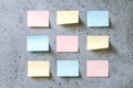 Colorful empty sticky notes on a grey textured background