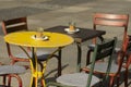 Colorful ensemble of vintage or grunge seating with round and square metal tables and metal chairs in the pedestrian zone Royalty Free Stock Photo