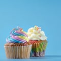 Colorful and enteresting cupcake isolated on blue background studio close up shot.