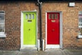 Colorful entrance doors to low-rise brick-fronted homes