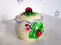 Colorful ÃÂeramic sugar bowl with decorations of a flower and a ladybug on a leaf