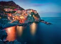 Colorful evening cityscape of Manarola, second city of Cique Terre sequence of hill cities. Dark summer scene of Liguria, Italy, E