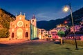 Colorful evening view of cityscape of Church of San Giovanni Battista of Riomaggiore. Night cityscape of Riomaggiore, first city o