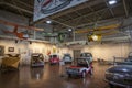 Colorful exotic cars and small airplanes hanging from the ceiling at Lane Motor Museum