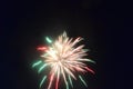 Colorful explosion in the night sky on 4th of July green red and white fireworks bright burst of light