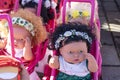 Colorful eyed baby with plastic hair sold outside in front of store for girls.