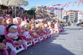 Colorful eyed baby with plastic hair sold outside in front of store for girls.