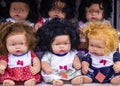 Colorful eyed baby with plastic hair sold outside in front of store for girls.