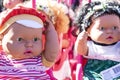 Colorful eyed baby with plastic hair sold outside in front of store for girls.