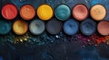 Colorful eyeshadow palette on dark textured background, top view