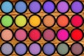 Colorful eyeshadows in black boxes on the wooden Royalty Free Stock Photo