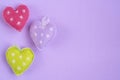 Colorful fabric hearts on purple background for greeting card Royalty Free Stock Photo