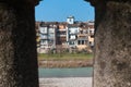 Colorful Facade along the River in Parma, Italy: View trough Columns