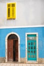 Colorful facade, blue wall, yellow shutter in the historic center of Cres