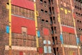 Colorful facade of old abandoned industrial ruin. Sealed windows, doors.