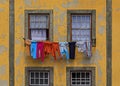 Colorful facade of a traditional house with peeling paint in the Ribeira with laundry hanging outside, Porto, Portugal