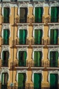 Colorful facade and windows with closed shutters in Madrid