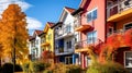 Colorful facades of houses in a row with autumn leaves. Royalty Free Stock Photo