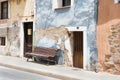 Colorful facades in a spanish village in summer. Wooden bench in front of the blue one.