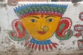 Colorful face painted on a wall in Varanasi India