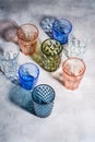 Colorful faceted and geometric drink glass, group of empty green, red, blue and transparent drinkware for beverage Royalty Free Stock Photo