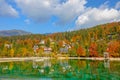 Colorful fall colored woods surround lakefront vacation houses by lake Jasna. Royalty Free Stock Photo