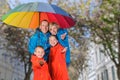 Colorful family have fun under rain