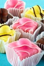 Colorful fancy iced fondant cakes. Royalty Free Stock Photo