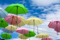 colorful fancy umbrella line decorate outdoor moving by wind on blue sky white cloud