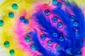 Colorful feathers and many blue glass round drops