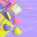 Colorful felt hearts set, handicraft supplies on wooden table with copy space for text. Handmade art gifts concept