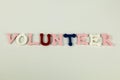 The word Volunteer formed with colorful felt letters Royalty Free Stock Photo