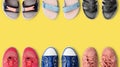 Colorful female shoes collection yellow background close up top view, women fashion sneakers, stylish gymshoes, summer sandals set Royalty Free Stock Photo