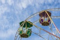 Colorful two cabins ferris wheel against blue sky as background