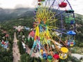 Colorful ferris wheel against the mountains and