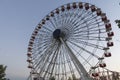 Colorful Ferris wheel of the amusement park in the blue sky and cloud background Royalty Free Stock Photo