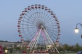 Colorful Ferris wheel of the amusement park in the blue sky and cloud background Royalty Free Stock Photo