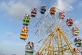 Colorful ferris wheel with blue sky and white clouds in the background Royalty Free Stock Photo