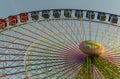 Colorful Ferris wheel in front of a blue sky. Big carousel in Gijon, Asturias, Spain