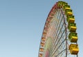 Colorful Ferris wheel in front of a blue sky. Big carousel in Gijon, Asturias, Spain