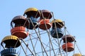 Colorful ferris wheel slowly moving against blue sky in the amusement park Royalty Free Stock Photo