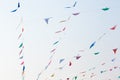 Colorful festive bunting flags against a blue sky and clouds background Royalty Free Stock Photo