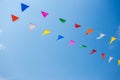 Colorful festive bunting flags against a blue sky and clouds background Royalty Free Stock Photo