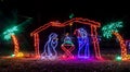 Colorful festive Holiday Christmas Light display of Nativity scene and palm trees Royalty Free Stock Photo