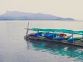 Colorful fiberglass kayaks on outdoor storage in the sea