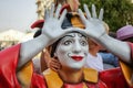 Colorful figure of a clown with arms raised