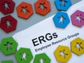 Colorful figurines and papers about Employee Resource Groups ERGs.