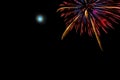 Colorful firework with full moon next to it