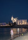 Colorful fireworks on the beach. Kids on the front playing